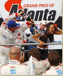 JJ Lehto sprays Miss Chevy Grand Prix with champagne