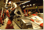 Plenty of action: Emanuele Pirro leaves the Infineon Audi R8 (#1) after he helped his team mate Frank Biela with the seatbelt