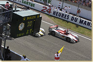 After 24 hours at Le Mans Emanuele Pirro crosses the finish line first